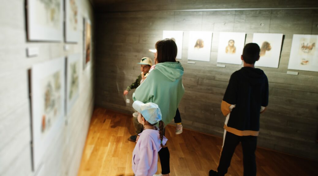 Mother with children exploring expositions in museum halls.